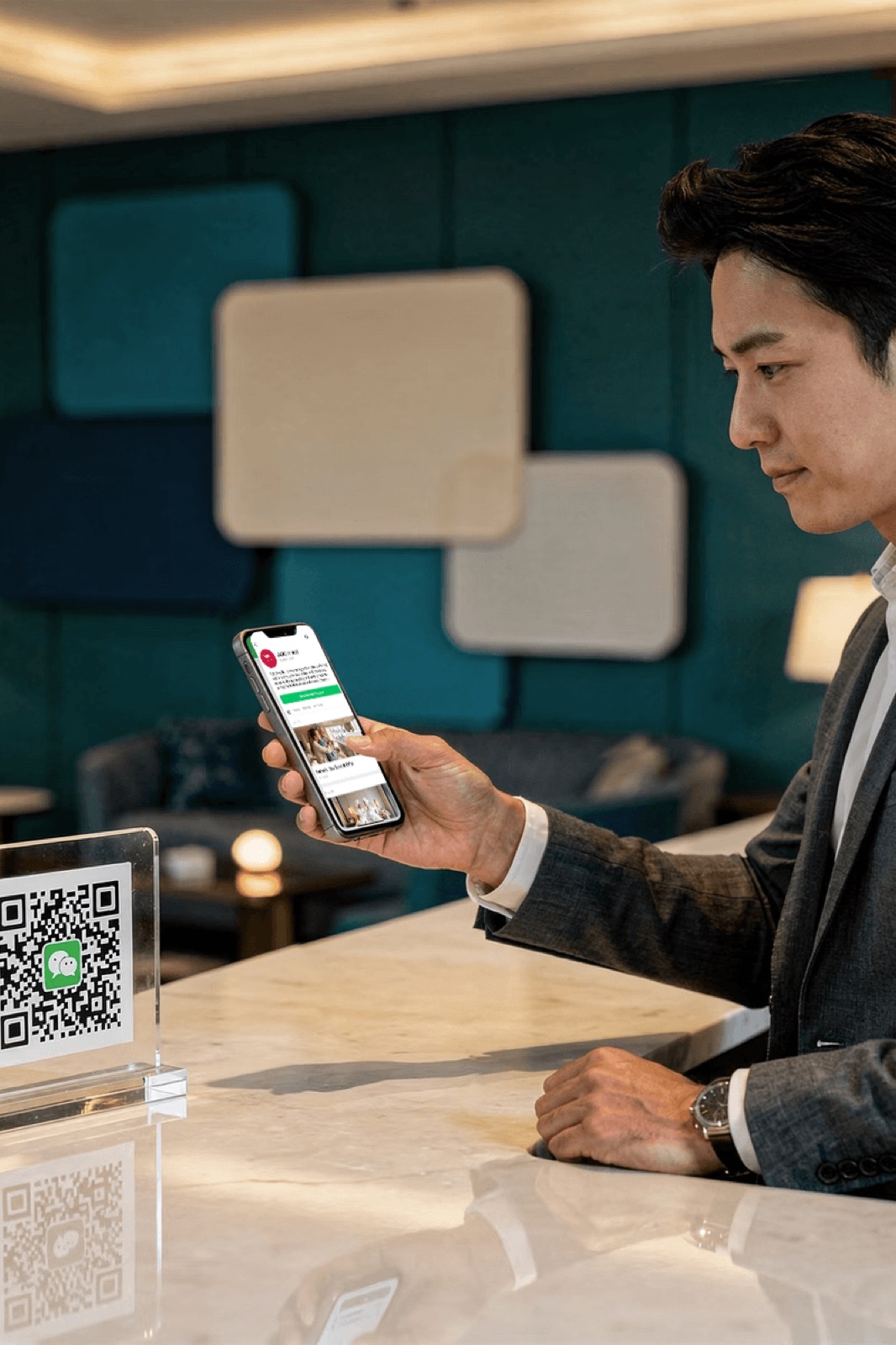 Hotel guest scanning a WeChat QR code at the front desk